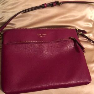 Crossbody Kate Spade bag. Rectangular shape. A purple plum color. Very roomy.
